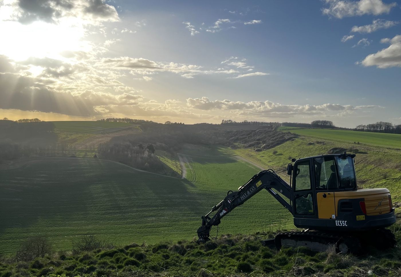 Volvo EC55C excavator working on the North Wessex Downs above Andover at last light