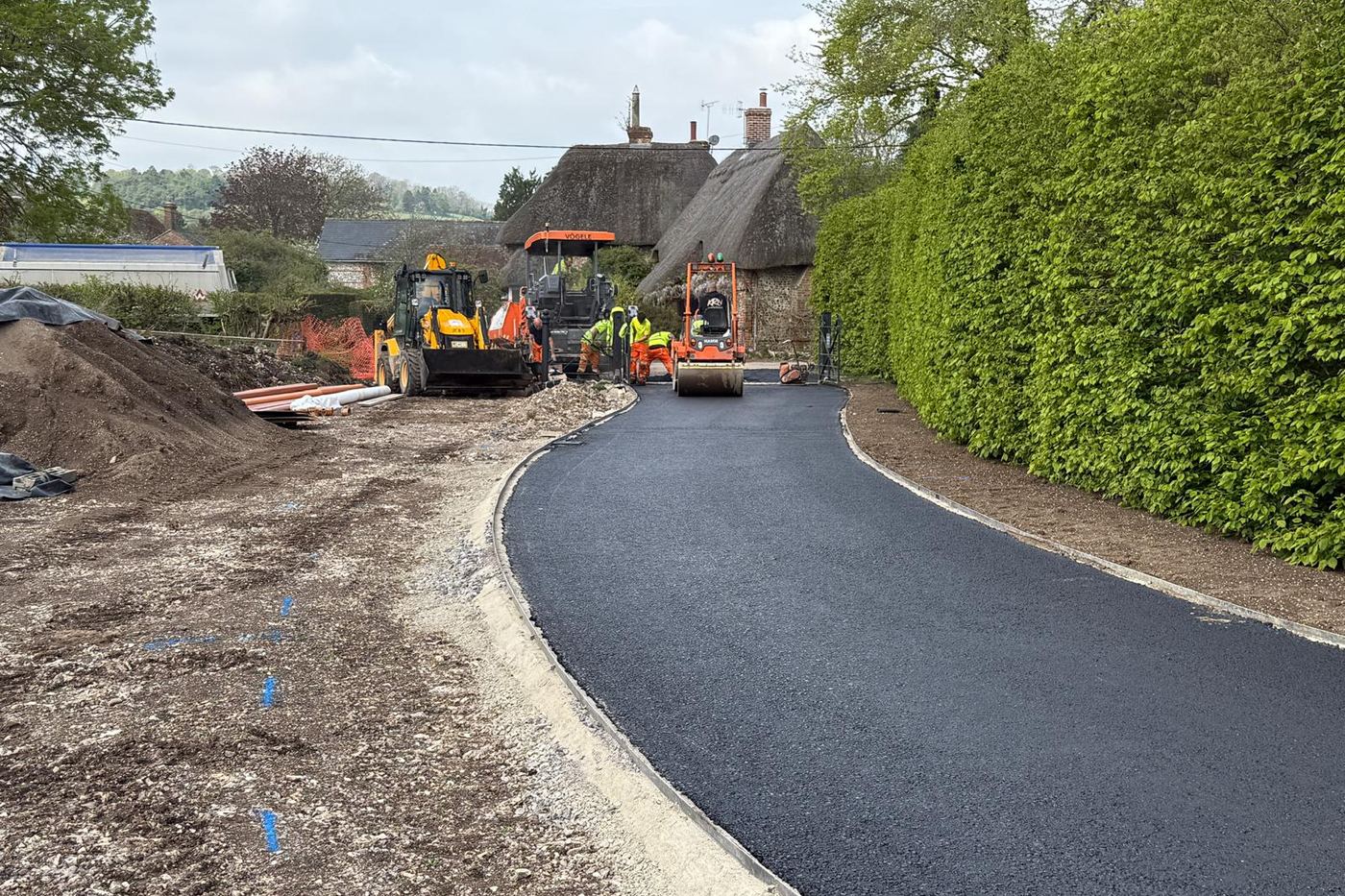 New driveway being surfaced and rolled at a thatched village property near Andover