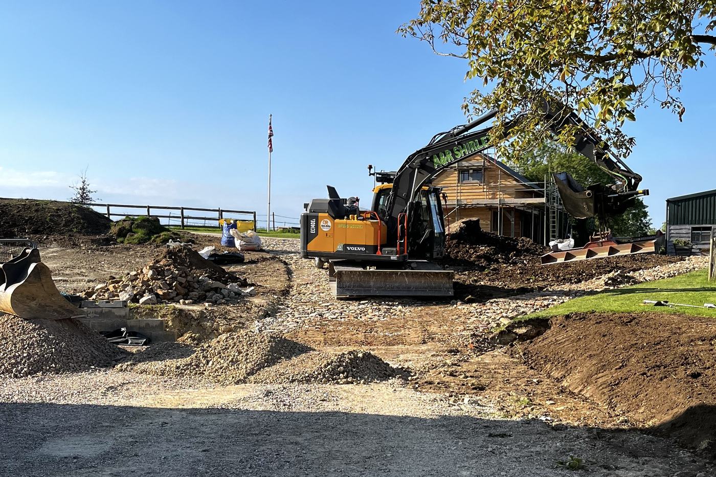 Excavator forming a new driveway and groundworks at a country property