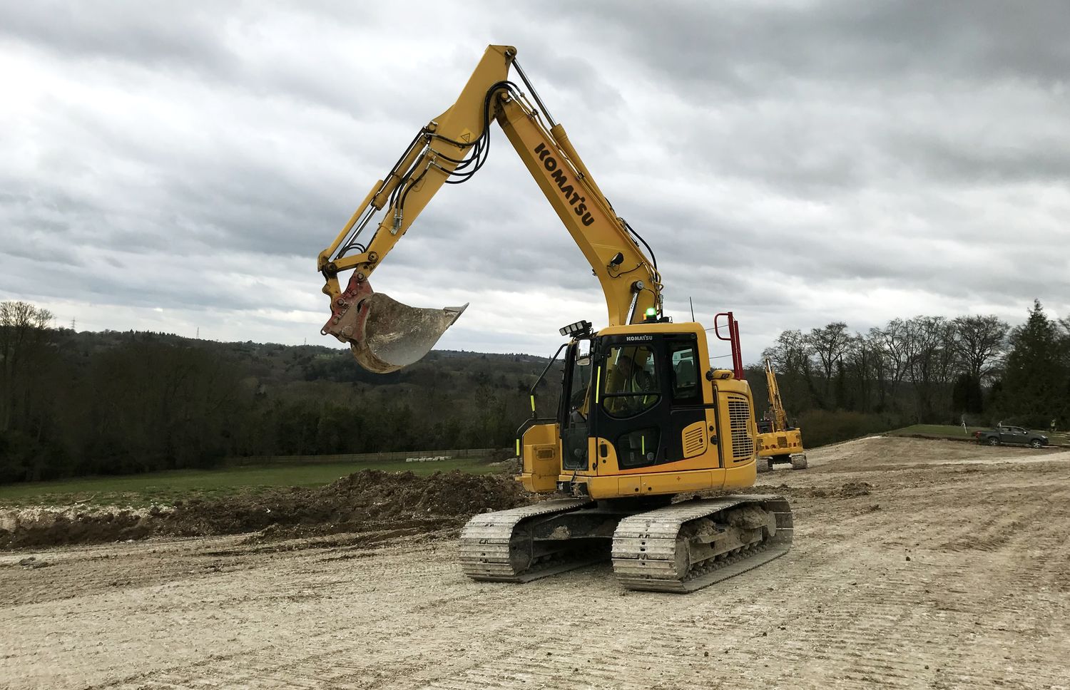 Large tracked excavator forming a haul road on a bulk earthworks site